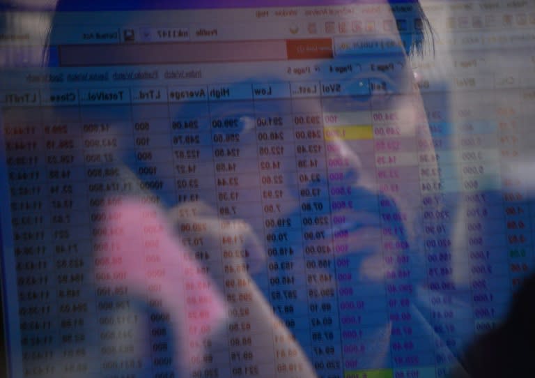 A Pakistani stockbroker looks at the latest share prices on a monitor during a trading at the Pakistan Stock Exchange in Karachi