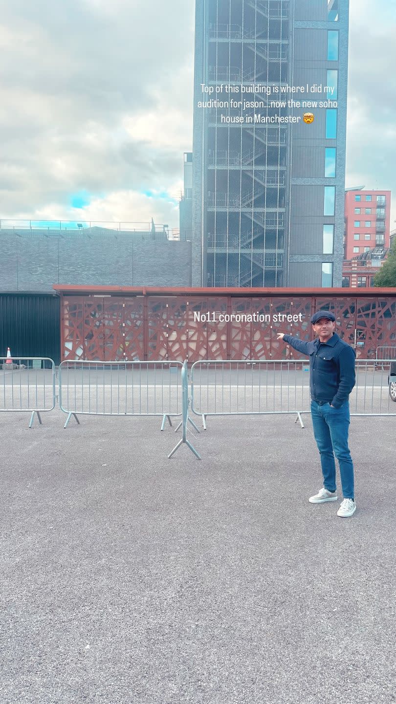 coronation street actor ryan thomas standing in front of a tower block
