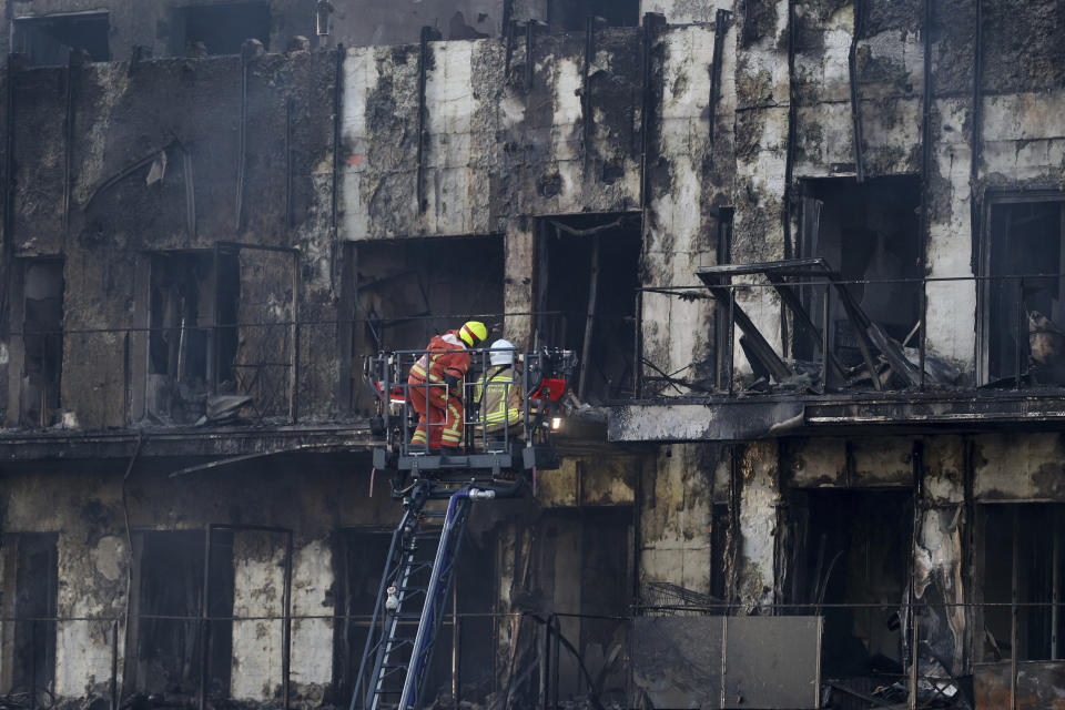 Firefighters work at a burned block building in Valencia, Spain, Friday, Feb. 23, 2024. A fire has engulfed two residential buildings in the eastern Spanish city of Valencia, killing at least four people and injuring at least 13 others. Emergency services reported that at least 19 people were still missing several hours after the fire started. (AP Photo/Alberto Saiz)