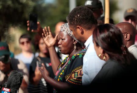 Agnes Hasam, a family friend of the Alfred Olango, speaks to protesters gathered at the El Cajon Police Department headquarters to protest fatal shooting of an unarmed black man Tuesday by officers in El Cajon, California, U.S. September 28, 2016. REUTERS/Earnie Grafton