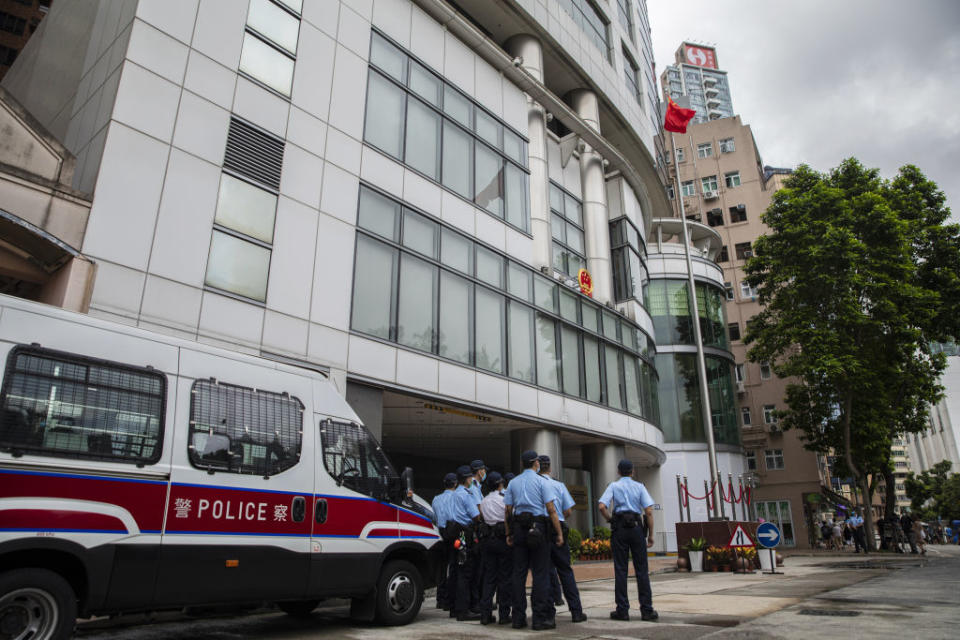 Police officers stand guard outside the Office for Safeguarding National Security in Hong Kong, set up at the Metropark Hotel, in Hong Kong on July 8, 2020. | Chan Long Hei—Bloomberg/Getty Images