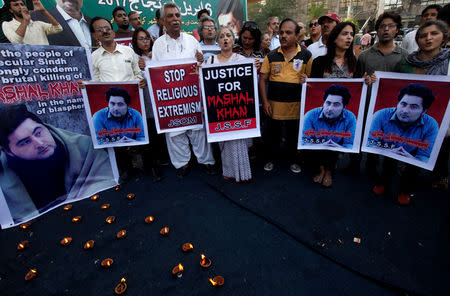 FILE PHOTO: People hold signs as they chant slogans to condemn the killing of Mashal Khan, student of Abdul Wali Khan University after he was accused of blasphemy, during a protest in Karachi, Pakistan, April 22, 2017. REUTERS/Akhtar Soomro/File Photo