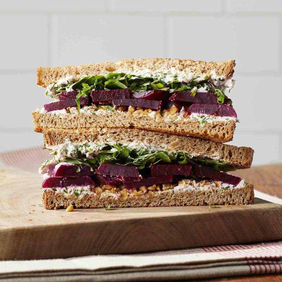<p>This pickled beet, arugula and goat cheese sandwich is peppery with creamy notes from the goat cheese and sweet and tangy undertones from the pickled beets. Chopped walnuts add nuttiness and crunch to this easy sandwich.</p> <p> <a href="https://www.eatingwell.com/recipe/7994089/pickled-beet-arugula-herbed-goat-cheese-sandwich/" rel="nofollow noopener" target="_blank" data-ylk="slk:View Recipe" class="link ">View Recipe</a></p>