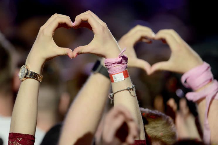 Fans making heart shapes with their hands at One Love Manchester concert. (Dave Hogan via AP)