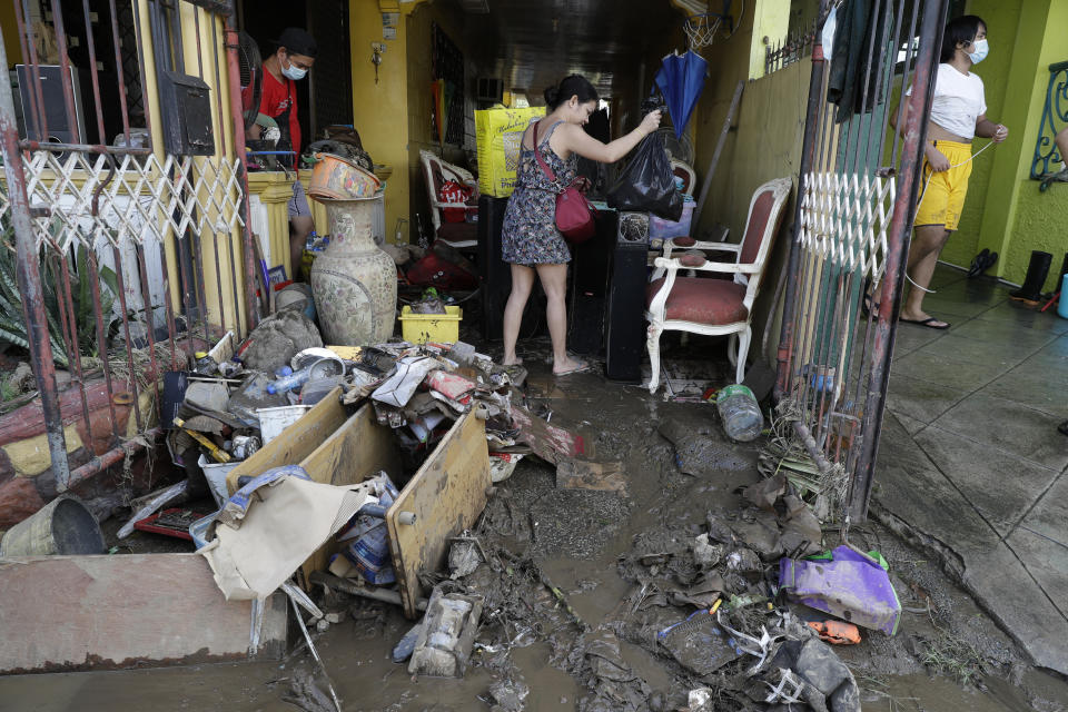 Residents try to save belongings after floodwaters caused by Typhoon Goni rose inside their village in Batangas city, Batangas province, south of Manila, Philippines on Monday, Nov. 2, 2020. Super typhoon Goni left wide destruction as it slammed into the eastern Philippines with ferocious winds early Sunday and about a million people have been evacuated in its projected path. (AP Photo/Aaron Favila)