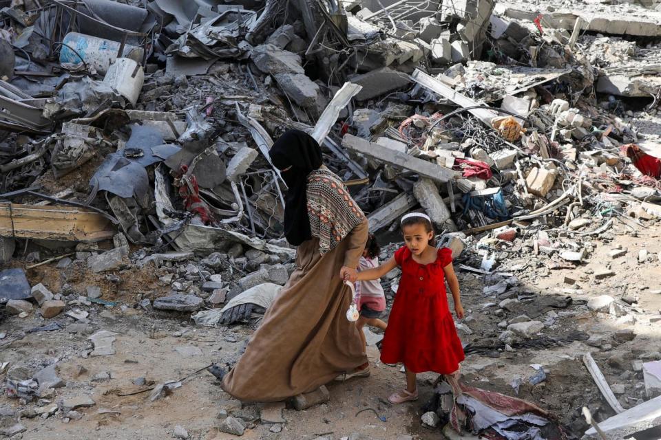 PHOTO: A woman and child walk among debris, aftermath of Israeli strikes at the area, where Israeli hostages were rescued on Saturday, as Palestinian death toll rises to 274, June 9, 2024. (Abed Khaled/Reuters)