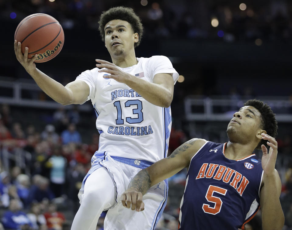 FILE - In this March 29, 2019, file photo, North Carolina's Cameron Johnson (13) heads to the basket past Auburn's Chuma Okeke (5) during the first half of a men's NCAA tournament college basketball Midwest Regional semifinal game, in Kansas City, Mo. Johnson is a first-round prospect in Thursday's NBA draft. (AP Photo/Charlie Riedel, File)