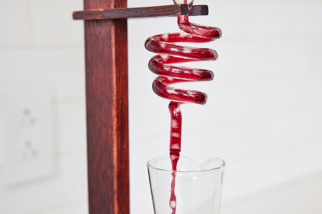 <p>Serious Eats / Fred Hardy</p> A look at a wine decanter tower in action.