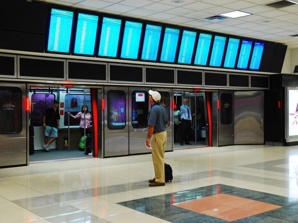 Passengers looks at Atlanta departure board.