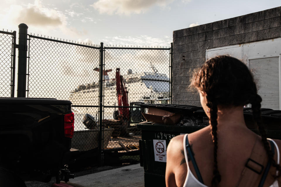 Sarah Renee Oźlański stands to watch the Grand Celebration start to dock. Oźlański waits for her Bahamian friend and infant to come on land and host them temporarily in West Palm Beach Sept. 18, 2019. (Photo: Maria Alejandra Cardona for HuffPost)