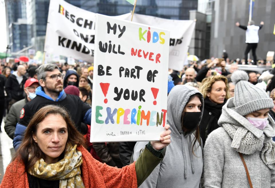 Demonstrators march during a protest against coronavirus measures in Brussels, Belgium, Sunday, Dec. 5, 2021. Kindergartens and primary schools will now close for the holiday season a week early, on Dec. 20, children must wear masks from the age of 6. and attendance at indoor events is limited to a maximum of 200 people. (AP Photo/Geert Vanden Wijngaert)