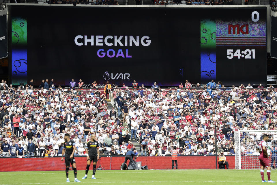 Players wait while a possible goal by Manchester City's Gabriel Jesus is checked by VAR during the English Premier League soccer match between West Ham United and Manchester City at London stadium in London, Saturday, Aug. 10, 2019. The goal was disallowed. (AP Photo/Kirsty Wigglesworth)