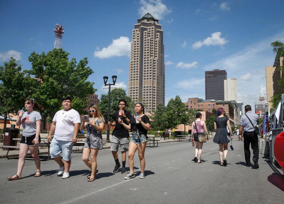 Attendees of the 2018 CelebrAsian festival walk along Locust Avenue in Des Moines on Friday, May 25, 2018.