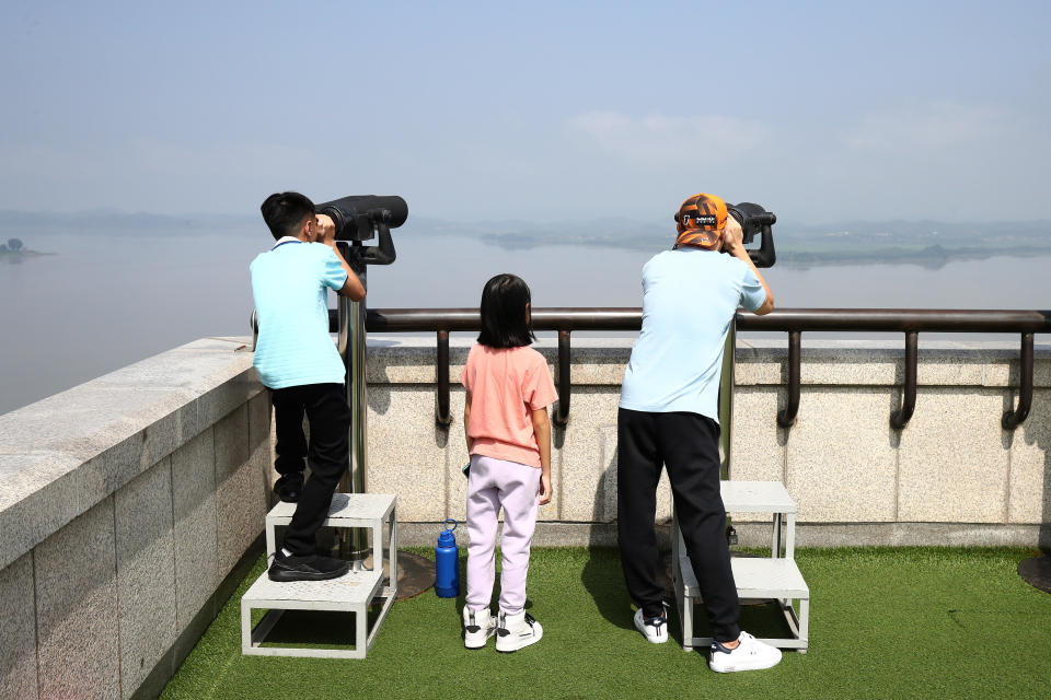  Tourists look over North Korea at the Unification Observation Platform, near the demilitarized zone (DMZ) on July 19, 2023, in Paju, South Korea. A U.S. soldier who had served in South Korea crossed the military demarcation line separating the two Koreas into North Korea without authorization. The man moved into the North during a tour at the Panmunjom Joint Security Area in the Demilitarized Zone (DMZ). / Credit: Getty Images