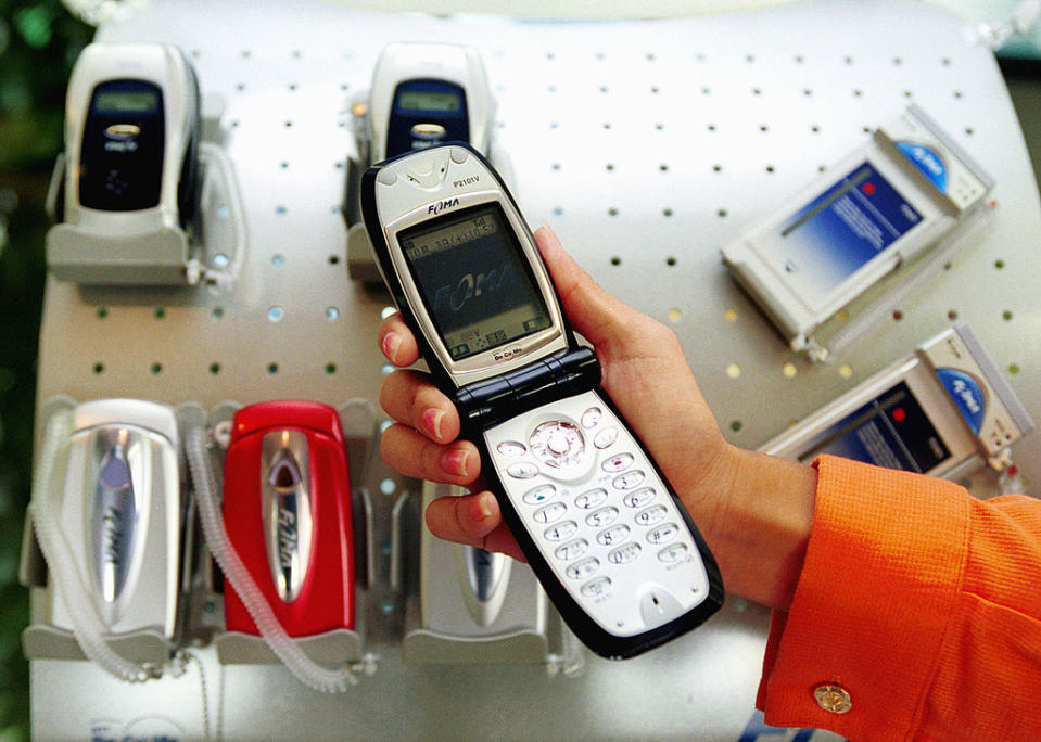 A flip phone is being displayed