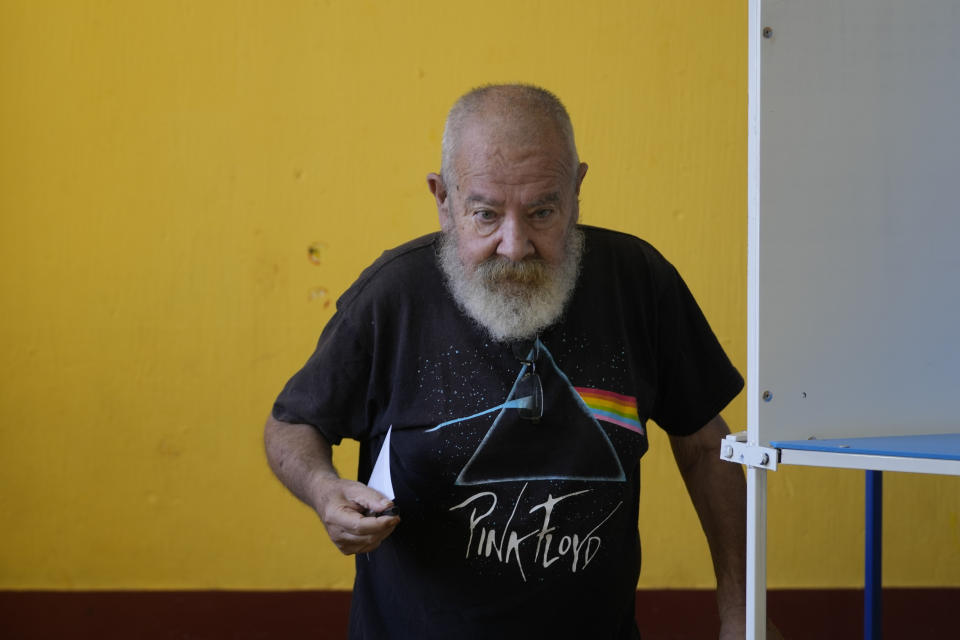 A man holds his ballot during a run-off presidential election in Guatemala City, Sunday, Aug. 20, 2023. (AP Photo/Moises Castillo)