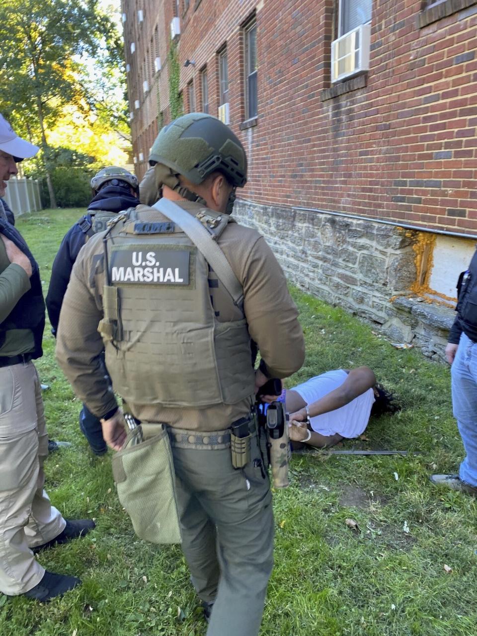 In this photo provided by the United States Marshals Service, marshals take Dayron Burney-Thorn into custody in Philadelphia's Germantown neighborhood on Monday, Oct. 23, 2023, after more than a year on the run. (United States Marshals Service via AP)
