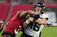 Jacksonville Jaguars quarterback Trevor Lawrence (16) is sacked by Tampa Bay Buccaneers safety Antoine Winfield Jr. during the first half of an NFL football game Sunday, Dec. 24, 2023, in Tampa, Fla. (AP Photo/Chris O'Meara)