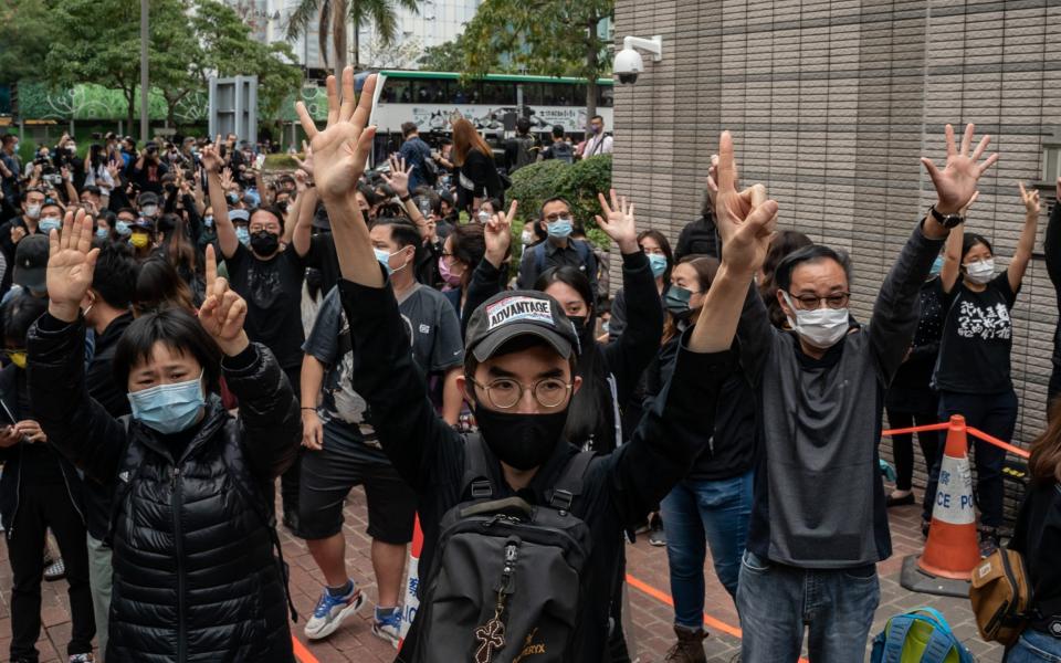 Pro-democracy activists protest outside a Hong Kong court where dozens of dissidents were being tried for subversion on March 1 - Anthony Kwan /Getty Images AsiaPac 
