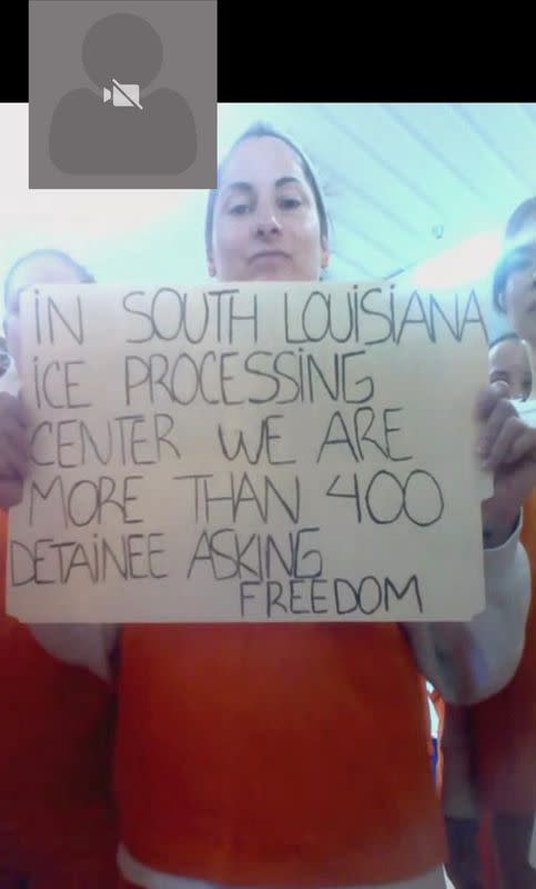 Migrants detained in an ICE detention facility in rural Louisiana display signs related to coronavirus disease