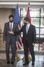 US Secretary of Defense Mark Esper, left, is received by Moroccan Foreign Minister Nasser Bourita, right, in Rabat, Morocco, Friday, Oct. 2, 2020. The visit is part of US Defense Secretary Mark Esper's North Africa tour and is his first visit to Africa as defense secretary. (AP Photo/Mosa'ab Elshamy)