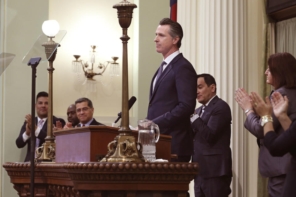 In this photo taken Tuesday, Feb. 12, 2019, California Gov. Gavin Newsom receives applause after delivering his first state of the state address to a joint session of the legislature at the Capitol in Sacramento, Calif. Newsom said the state's consumers should get a "data dividend" from technology companies, like Google and Facebook, who are make by capitalizing on the personal data they collect. (AP Photo/Rich Pedroncelli)