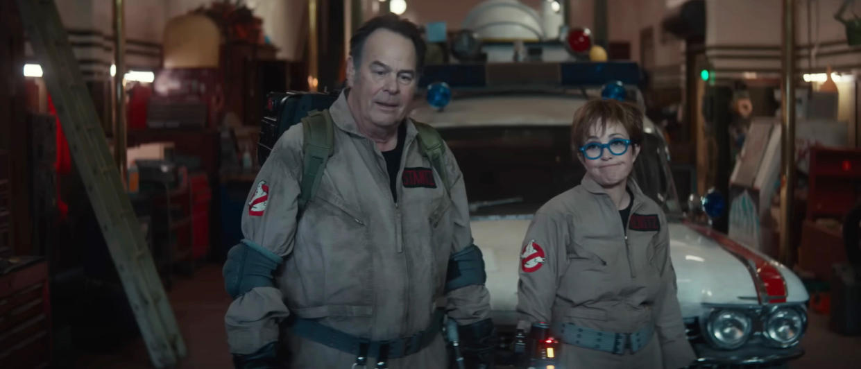  Dan Aykroyd and Annie Potts stand together in uniform in Ghostbusters: Frozen Empire. 