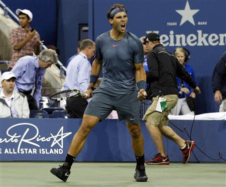 Rafael Nadal of Spain celebrates defeating compatriot Tommy Robredo during their men's quarter-final matchat the U.S. Open tennis championships in New York September 4, 2013. REUTERS/Adam Hunger