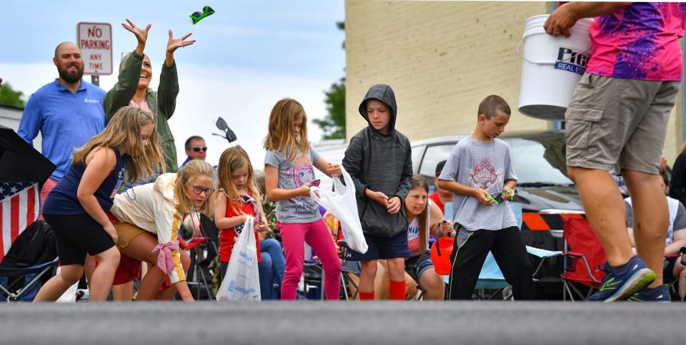 Spectators collect candy and other items during the St. Joseph Lions Club Fourth of July Parade Monday, July 4, 2022, in downtown St. Joseph. 