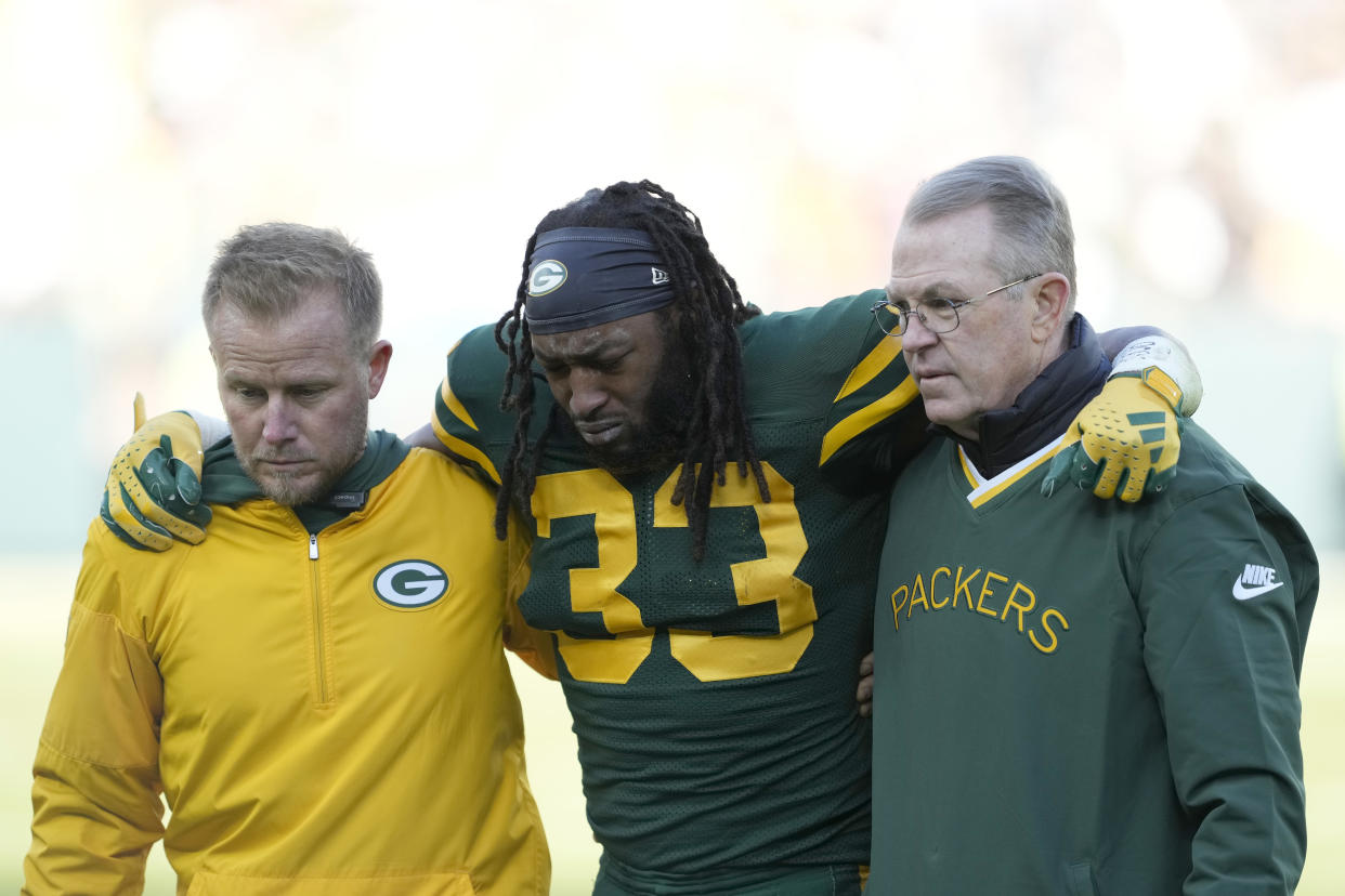 GREEN BAY, WISCONSIN - NOVEMBER 19: Aaron Jones #33 of the Green Bay Packers is helped off the field after being injured in the second quarter against the Los Angeles Chargers at Lambeau Field on November 19, 2023 in Green Bay, Wisconsin. (Photo by Patrick McDermott/Getty Images)