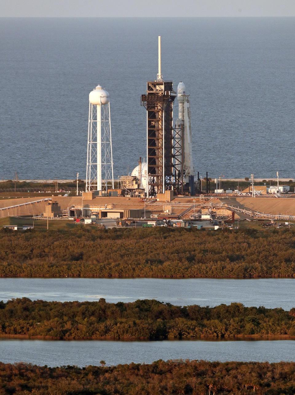 A Falcon Heavy SpaceX rocket sits on pad 39A at the Kennedy Space Center in Cape Canaveral, Fla., after the launch was scrubbed Wednesday, April 10, 2019. SpaceX will try again to launch the rocket tomorrow. (AP Photo/John Raoux)