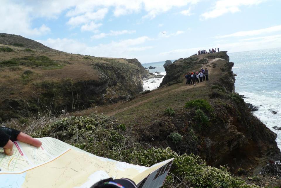 This October 2011 photo shows Timothy McCarthy, of Berkeley, Calif., consulting a trail map at Point Reyes National Seashore in Marin County, Calif., north of San Francisco, as part of a series of bicycle excursions in Northern California. This part of the tour included a hiking and mountain bike jaunt along some of the park’s many trails. (AP Photo/Paula Froke)