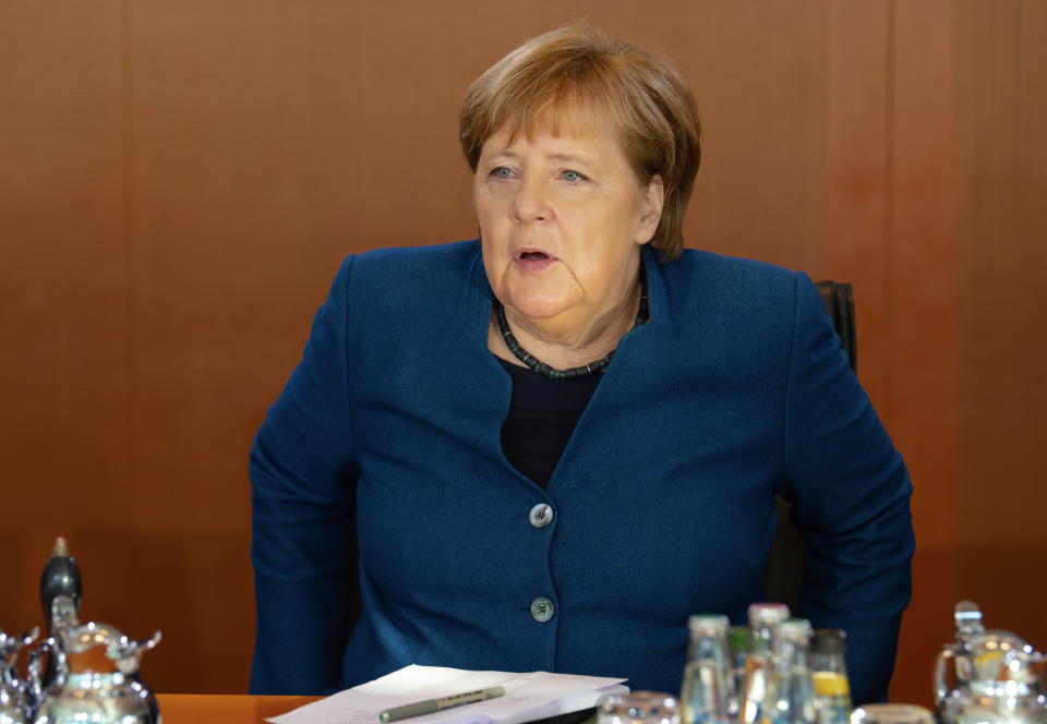 German Chancellor Angela Merkel arrives for the weekly cabinet meeting of the German government at the chancellery in Berlin, Germany, Wednesday, Feb. 5, 2020. (AP Photo/Jens Meyer)