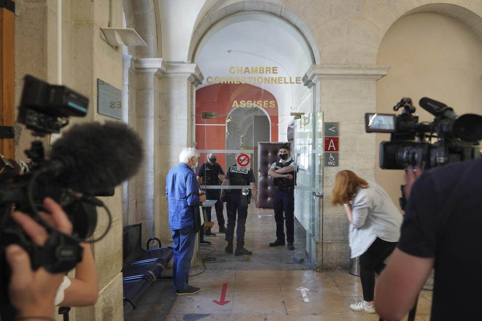 Reporters wait outside the courtroom as the 28-year-old man who slapped French President Emmanuel Macron is tried, facing possible jail time and a fine if found guilty of assaulting a public official, Thursday, June 10, 2021 in Valence, central France. Damien Tarel was quickly arrested after the swipe Tuesday that caught Macron in the face with an audible thwack as the French leader was greeting a crowd in southeast France. (AP Photo/Laurent Cirpriani)