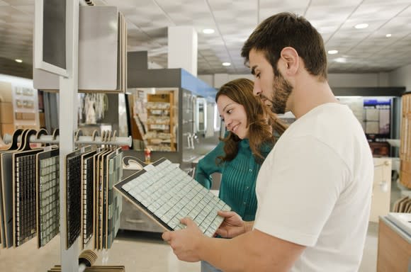 Young man and woman shopping in a tile store.