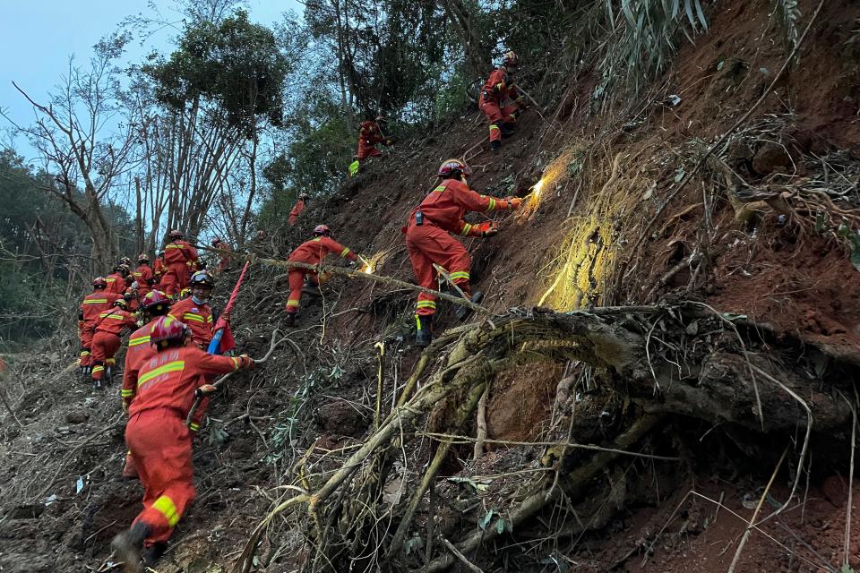 In this photo released by Xinhua News Agency, rescuers conduct search operations at the site of a plane crash in Tengxian County in southern China’s Guangxi region on Tuesday (AP)