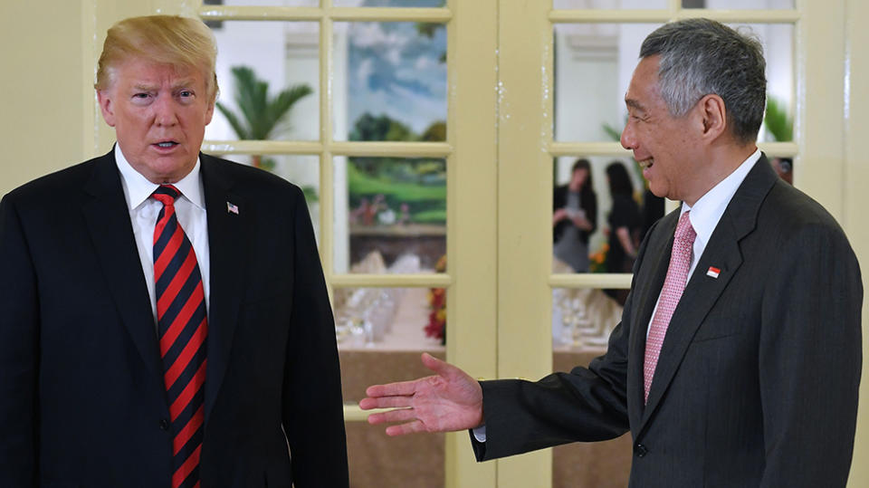 Donald Trump, pictured here with Singapore’s Prime Minister Lee Hsien Loong, is said to have access to America’s nuclear arsenal while he travels. Source: Getty
