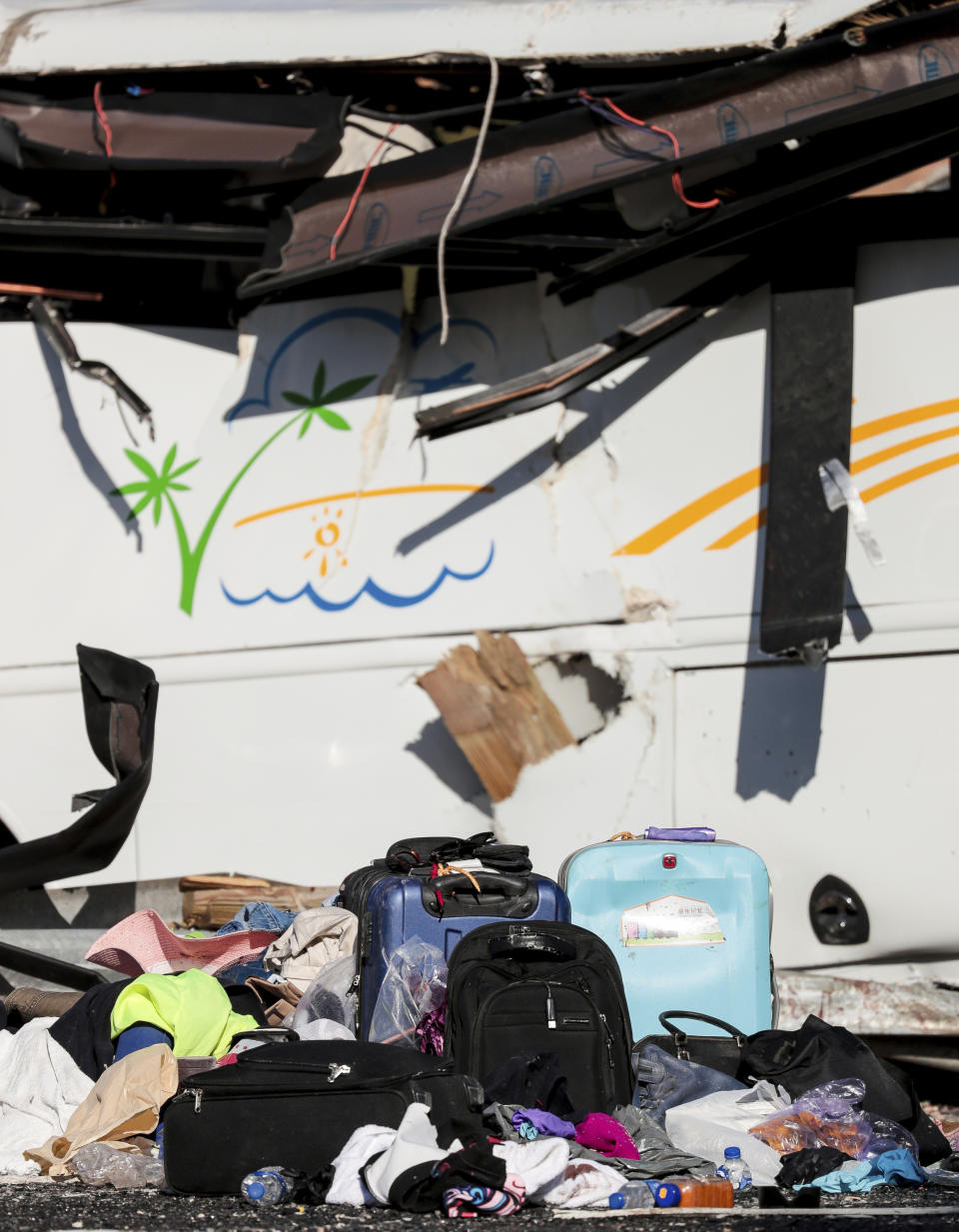 Luggage sits on the roadway at the scene where at least four people were killed in a tour bus crash near Bryce Canyon National Park, Friday, Sept. 20, 2019, in Utah. (Spenser Heaps/The Deseret News via AP)