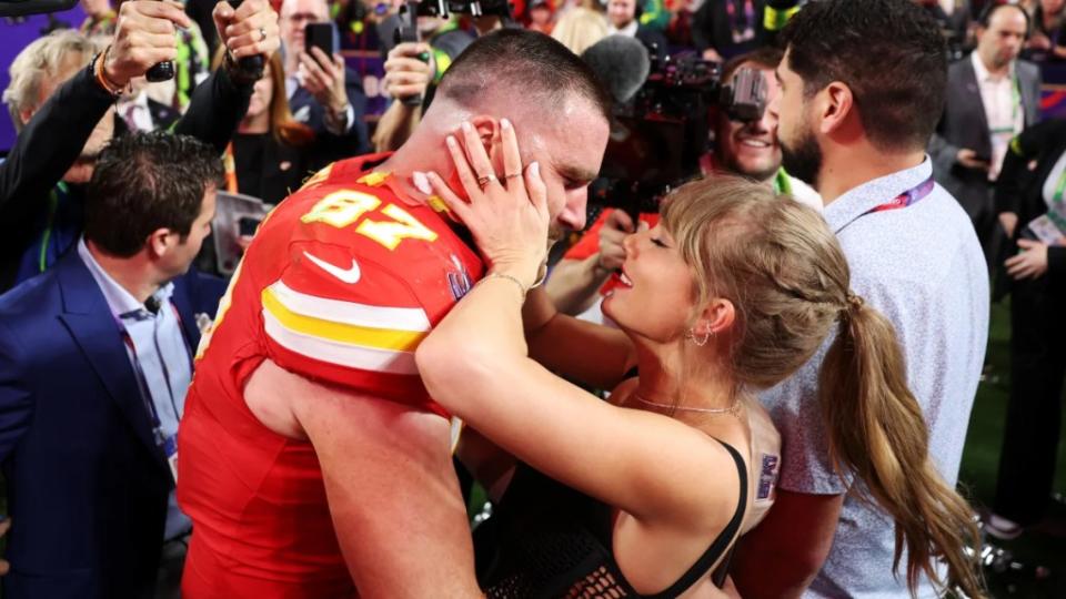 Taylor Swift and Travis Kelce embrace on the field at Super Bowl LVIII