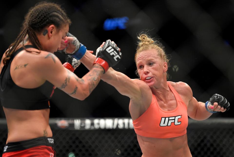 Holly Holm, right, punches Raquel Pennington during a UFC 184 mixed martial arts bantamweight bout in Los Angeles on Feb. 28, 2015.