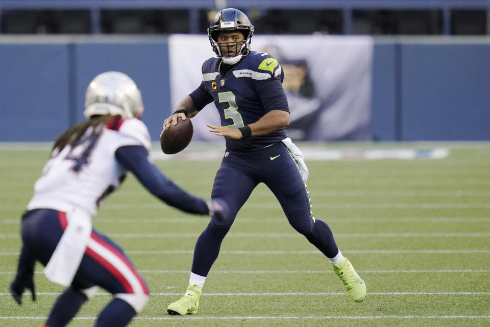 Seattle Seahawks quarterback Russell Wilson looks to pass against the New England Patriots during the first half of an NFL football game, Sunday, Sept. 20, 2020, in Seattle. (AP Photo/Elaine Thompson)