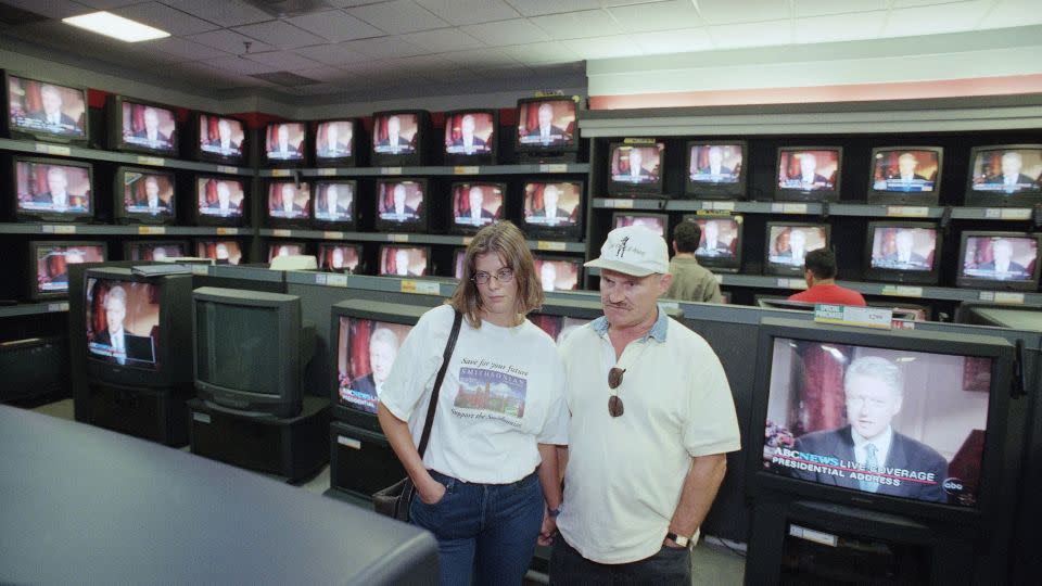 Dorthe Thomas and Harry Smallenburg view President Bill Clinton's speech about Monica Lewinsky on August 17, 1998, at an electronics store in Pasadena, California. - John Hayes/AP