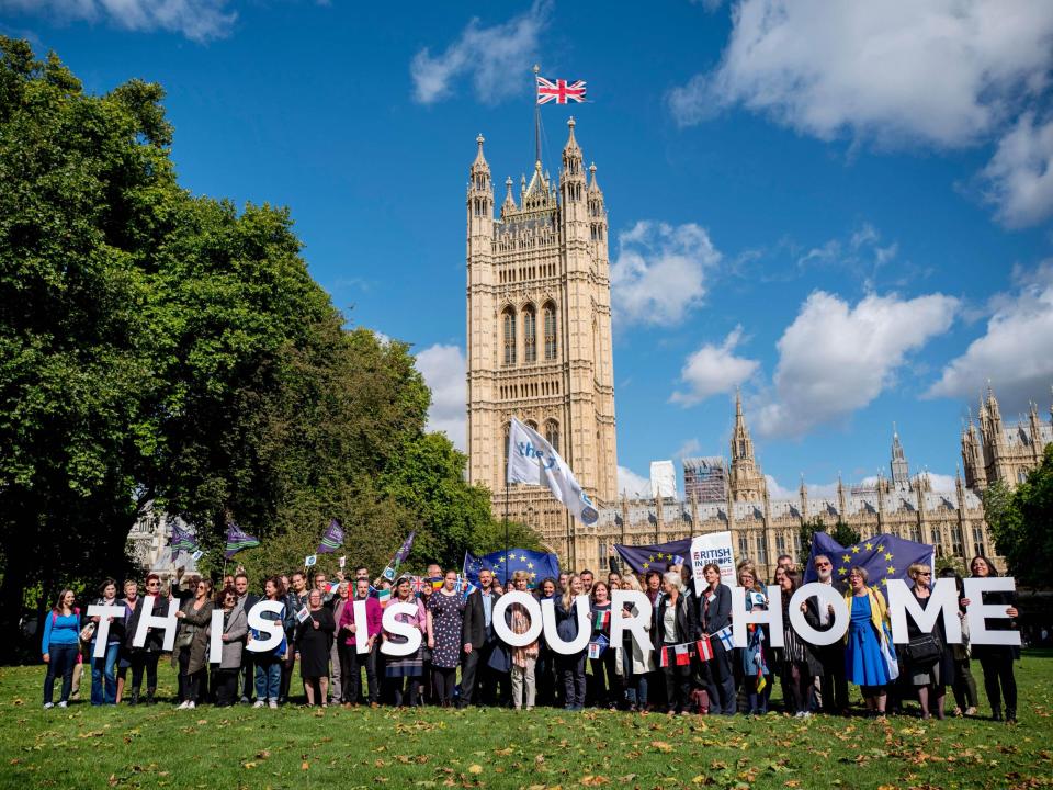 Demonstrators hold banners during a protest to lobby MPs to guarantee the rights of EU citizens living in the UK, after Brexit, outside the Houses of Parliament: AFP