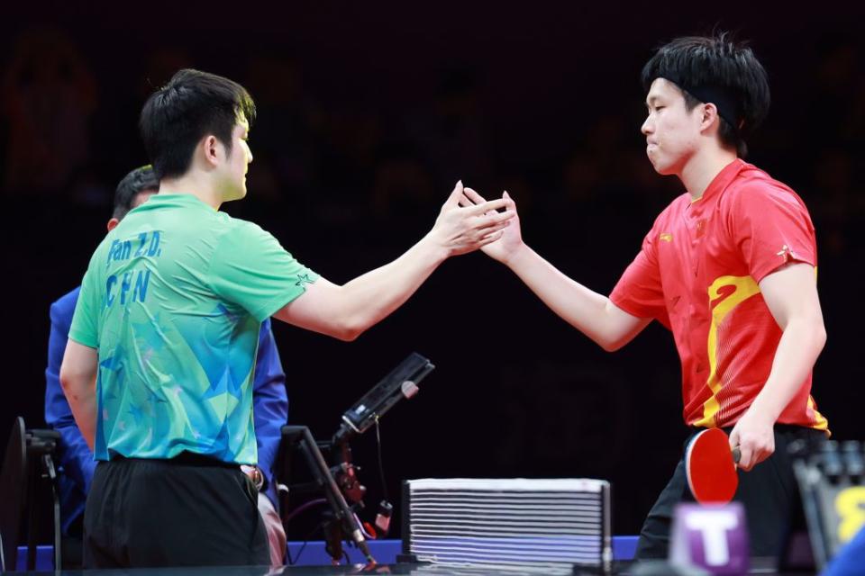 大陸桌球名將王楚欽(右)在單打金牌戰扳倒球王樊振東。（新華社）