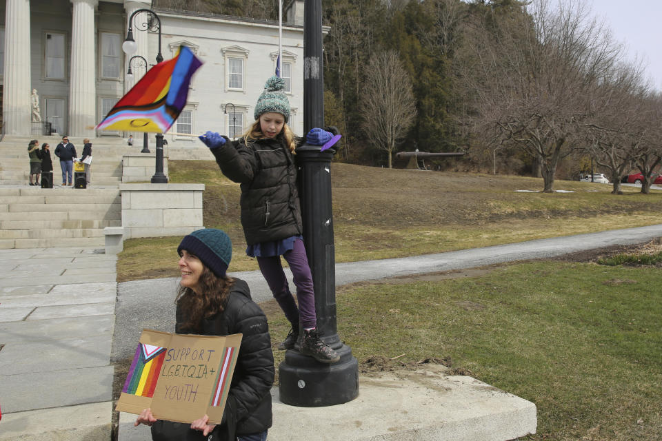 Chandra Bossard and her daughter Kai, 10, of Dummerston, Vt., attend a rally at the Vermont Statehouse in Montpelier, on Friday March 31, 2023 in support of transgender rights. The Vermont rally is one of many being held across the country on Friday. The rallies come at a time when Republicans in some state legislatures across the country are considering hundreds of separate bills that would limit transgender rights. (AP Photo/Wilson Ring)