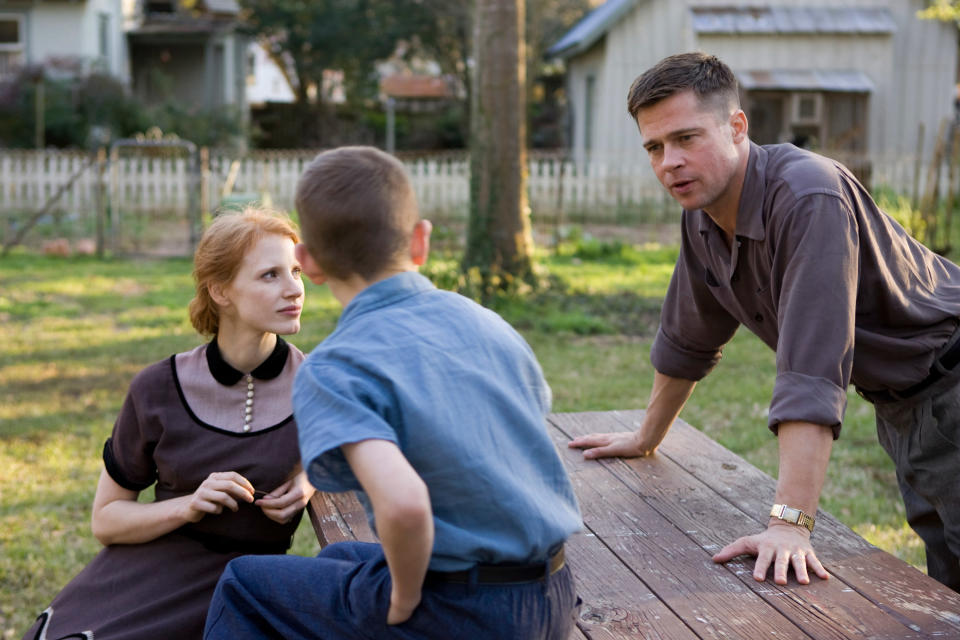 Three people at a picnic table