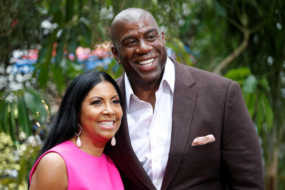 Former NBA basketball player Earvin Magic Johnson (R) and his wife Cookie Johnson pose at the premiere of the movie 