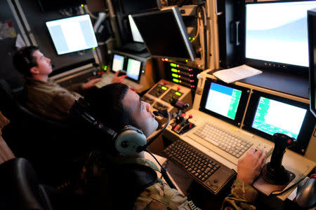 U.S. airmen control a U.S. Air Force drone from a command trailer at Kandahar Air Field, Afghanistan March 9, 2016. Picture taken March 9, 2016. REUTERS/Josh Smith