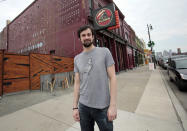 Slows restaurant co-owner Phillip Cooley stands in front of the restaurant on Michigan Ave in Detroit, Michigan, March 13, 2012. Strapped with a reputation for crime, blight and political corruption, Detroit city leaders are clutching the burgeoning revolution taking place on various levels of the food industry as a potential start of a comeback. REUTERS/Rebecca Cook