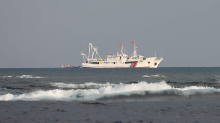 China Coast Guard vessels are pictured at the disputed Scarborough Shoal April 5, 2017. Picture taken April 5, 2017 REUTERS/Erik De Castro